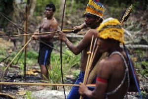 Munduruku Indian warriors prepare themselves as they approach a wildcat gold mine during a search for illegal mines and miners in their territory near the Das Tropas river, a major tributary of the Tapajos and Amazon rivers in western Para state January 17, 2014. The Munduruku tribe has seen their land encroached on by wildcat miners in search of gold, and the tribe's leaders travelled to the capital Brasilia last year to demand the federal government remove non-indigenous miners from their territory. Rather than wait for a court decision to start the process - which could take years - the Munduruku decided to take matters into their own hands and expel the wildcat miners. Picture taken January 17, 2014. REUTERS/Lunae Parracho (BRAZIL - Tags: ENVIRONMENT POLITICS) ATTENTION EDITORS: PICTURE 24 OF 26 FOR PACKAGE 'MAN HUNT FOR WILDCAT GOLD MINERS' TO FIND ALL IMAGES SEARCH 'MUNDURUKU' - RTX18Z1F